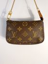Bolsa Louis Vuitton Pochette Monograma Mini