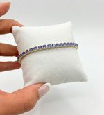 PULSEIRA REGULÁVEL RIVIERA CRAVEJADA COM ZIRCÔNIAS LILÁS BANHADO EM OURO 18K