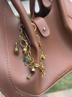 Charm e Pulseira Viagem Ouro
