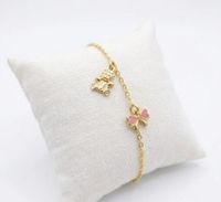 Foto do produto PULSEIRA INFANTIL REGULAVEL URSO E LAÇO ROSA COM RESINA BANHADA EM OURO 18K
