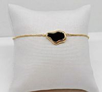 Foto do produto PULSEIRA REGULÁVEL ORGÂNICA COM RESINA PRETA BANHADO EM OURO 18K