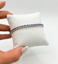 Foto do produto PULSEIRA REGULÁVEL RIVIERA CRAVEJADA COM ZIRCÔNIAS LILÁS BANHADO EM OURO 18K